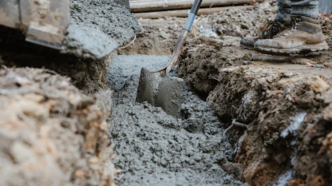 Digging beside a foundation to reach pipes